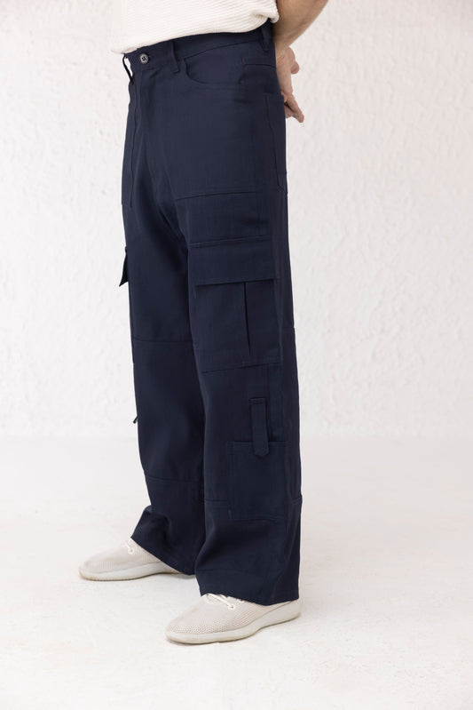 Side profile of dark blue wide leg cargo pants with clean finish and spacious pockets