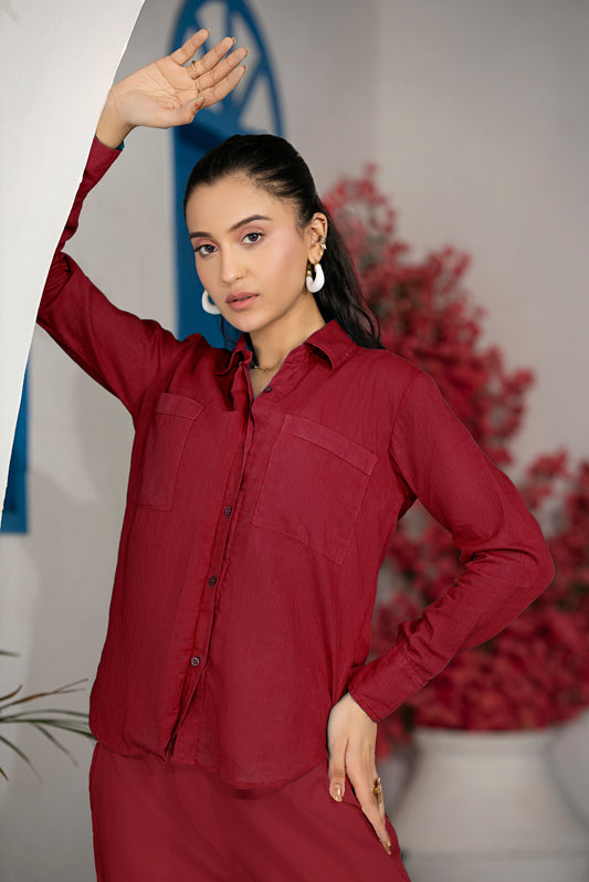 Close-up of red shirt pocket, buttons, and sleeve cuff