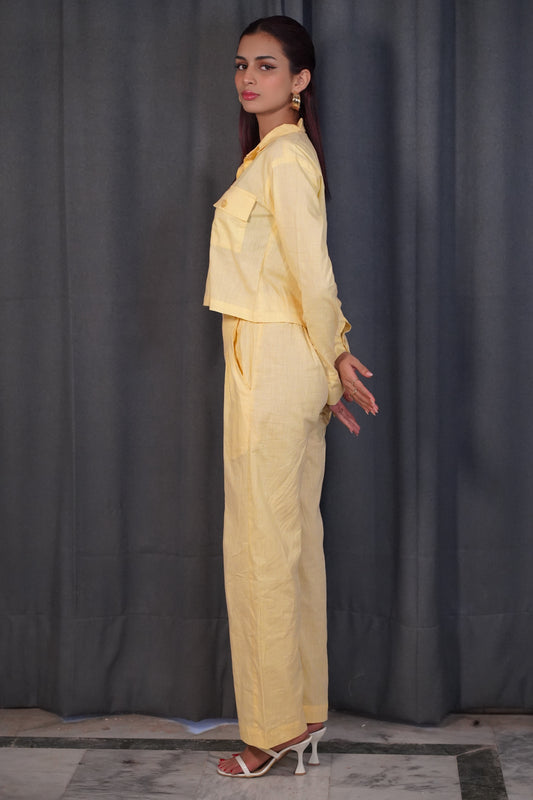 Side profile showing cuffed sleeve shirt with pockets and relaxed regular fit pants in yellow