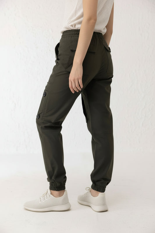 Side view of green twill cargo pants for men with black button detailing and tapered elastic hem