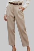 Beige pants worn by a person on a plain background