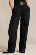 Black wide-leg pants with a belt on a neutral background