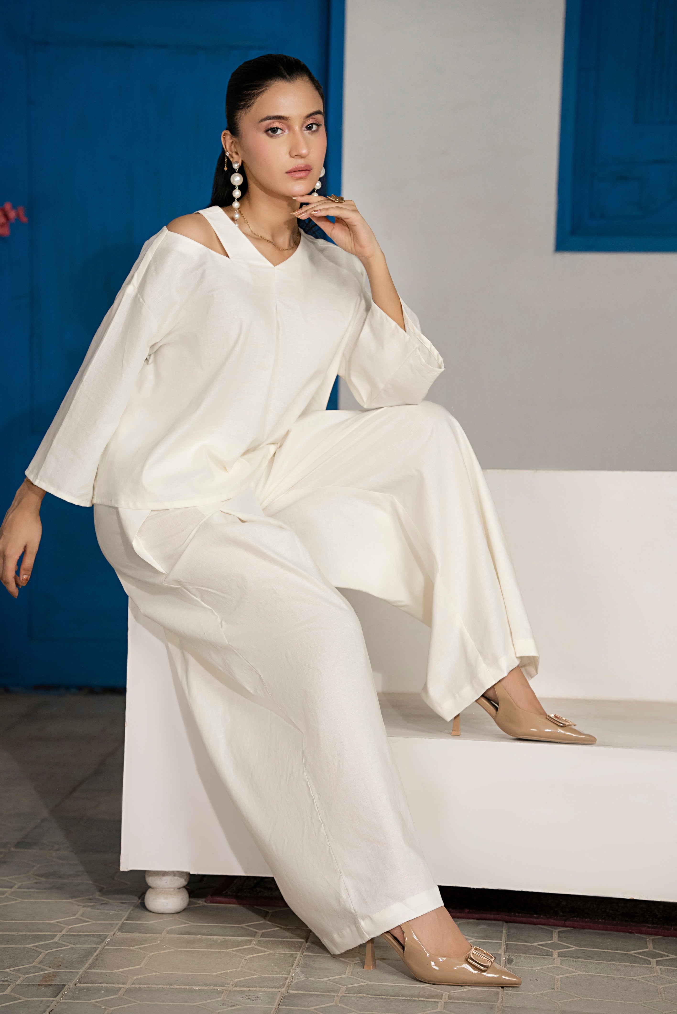 Model posing in Ivorycrest off-white slit pleat co-ord set showing fluid drape and elegant movement