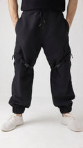 Front view of Nyxbound Strap Utility Cargo Pants in black with elastic waist and clean athletic design